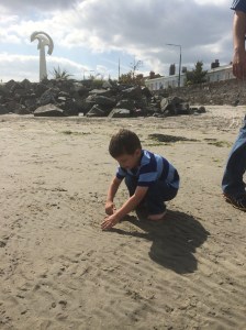 Isaac playing on the beach. Not having a bucket and shovel didn't stop him!